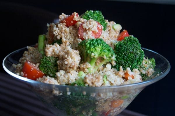 Vibrant Quinoa Salad with creamy balsamic dressing, featuring fluffy quinoa, steamed asparagus, broccoli, and carrots, served in a bowl.
