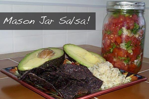 Vibrant Mason Jar Salsa with distinct layers of red beefsteak tomatoes and green jalapeno, scallion, and cilantro mixture, ready to be served.