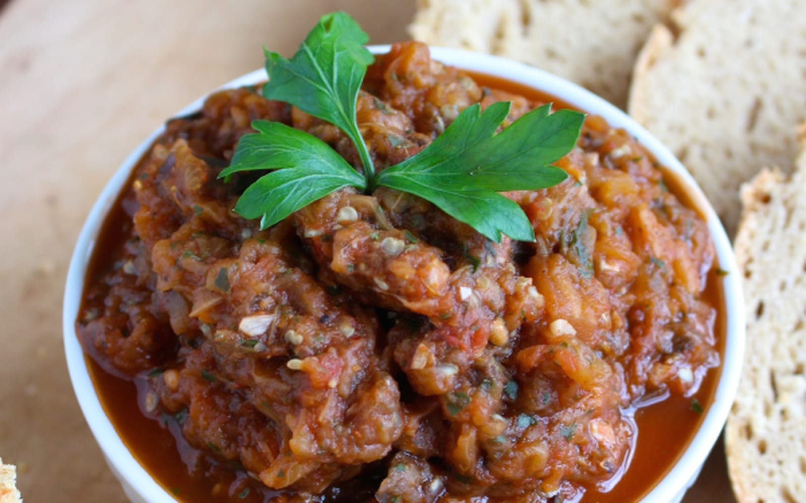 A bowl of Traditional Moroccan Eggplant Salad, garnished with fresh parsley, ready to be served warm or cold.