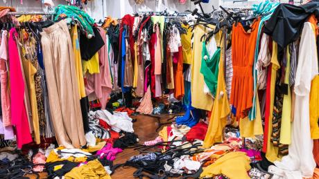 environmental cost fast fashion 2026 microplastics textile waste carbon emissions clothing garment care